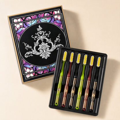 Six adult manual toothbrushes with medium-hard bristles and extended heads arranged beside a gift box - view 2