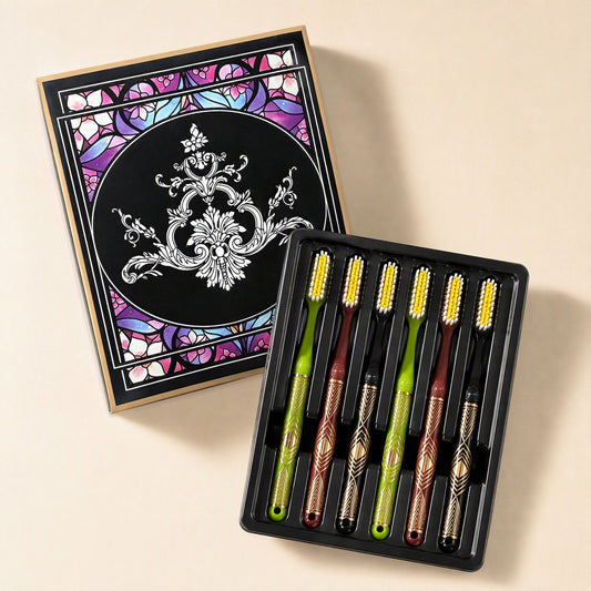 Six adult manual toothbrushes with medium-hard bristles and extended heads arranged beside a gift box - view 2