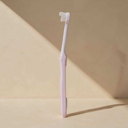 Manual toothbrush with a small head, soft bristles, and a single-tuft design - view 3