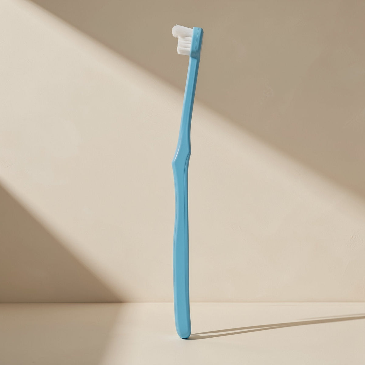 Manual toothbrush with a small head, soft bristles, and a single-tuft design - view 4