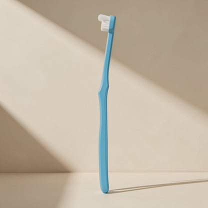Manual toothbrush with a small head, soft bristles, and a single-tuft design - view 4
