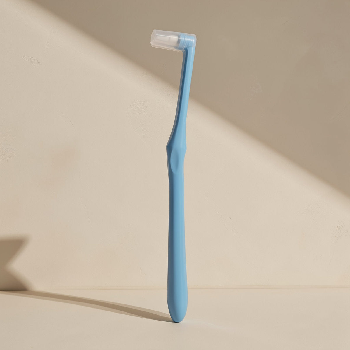 Manual toothbrush with a small tapered single-tuft head and soft bristles - view 4