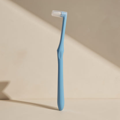 Manual toothbrush with a small tapered single-tuft head and soft bristles - view 4
