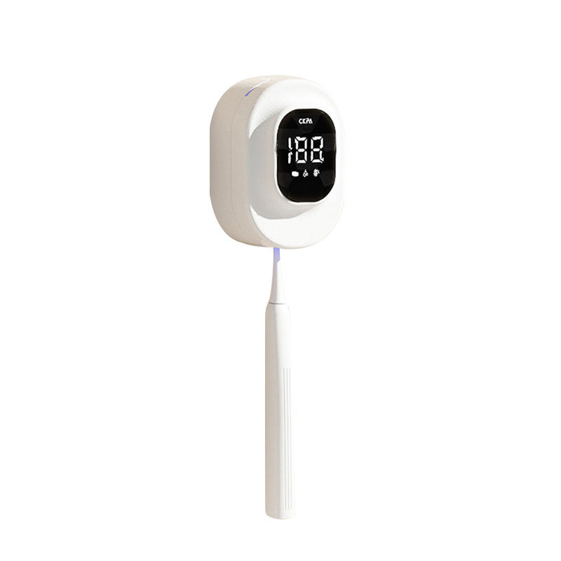White USB toothbrush holder shown with a toothbrush for scale