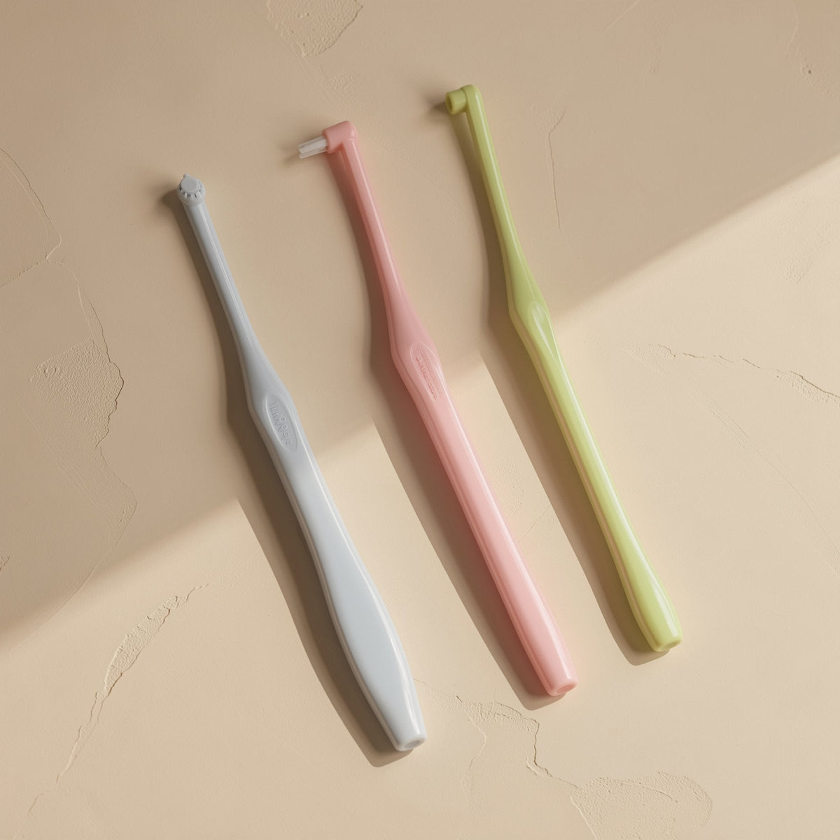 Manual single-head orthodontic toothbrush with pointed soft bristles and a single hole - view 2