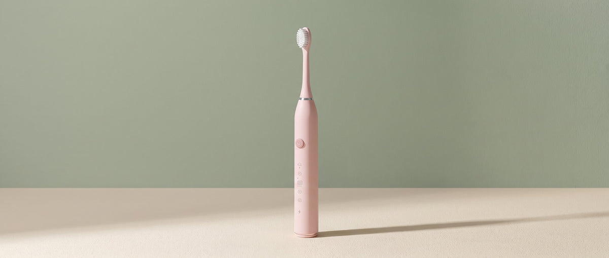 Pink OralCove electric toothbrush in a softly lit muted-sage routine-builder scene.
